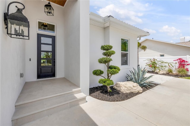 102 Inlet Shores Dr, New Smyrna Beach, FL 32168 - property entrance featuring stucco siding and fence