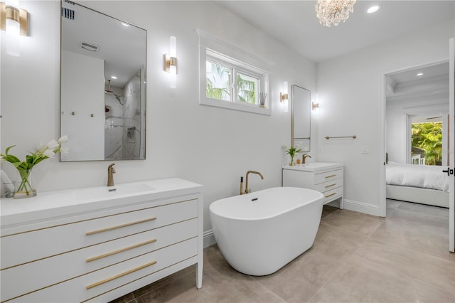 102 Inlet Shores Dr, New Smyrna Beach, FL 32168 - ensuite bathroom with a walk in shower, two vanities, recessed lighting, baseboards, and a freestanding bath