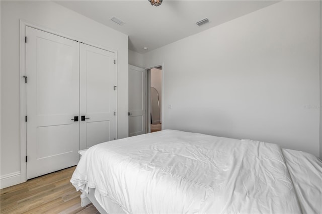 102 Inlet Shores Dr, New Smyrna Beach, FL 32168 - bedroom with light wood finished floors and a closet