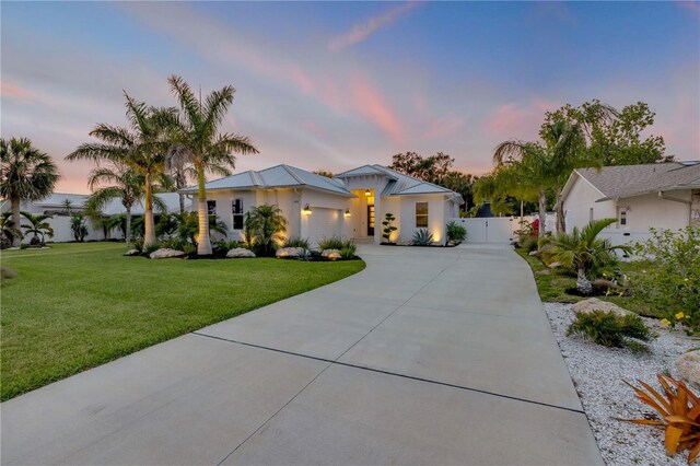 102 Inlet Shores Dr, New Smyrna Beach, FL 32168 - view of front of house featuring concrete driveway, an attached garage, and a gate