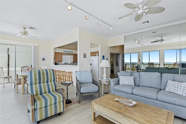 6320 S Atlantic Ave, New Smyrna Beach, FL 32169 - living room with ceiling fan, track lighting, light wood-style flooring, and crown molding