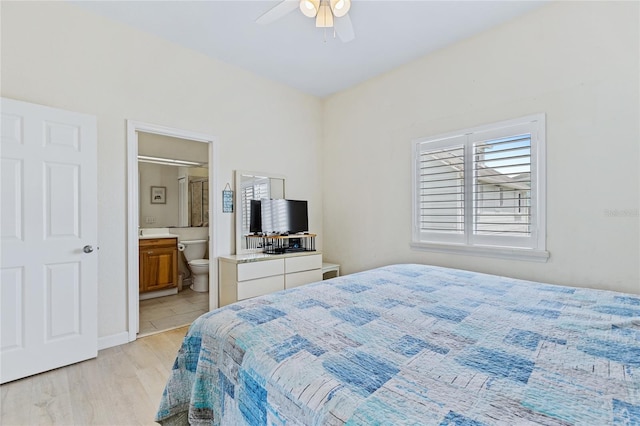 6320 S Atlantic Ave, New Smyrna Beach, FL 32169 - bedroom featuring light wood-style floors, connected bathroom, a ceiling fan, and baseboards
