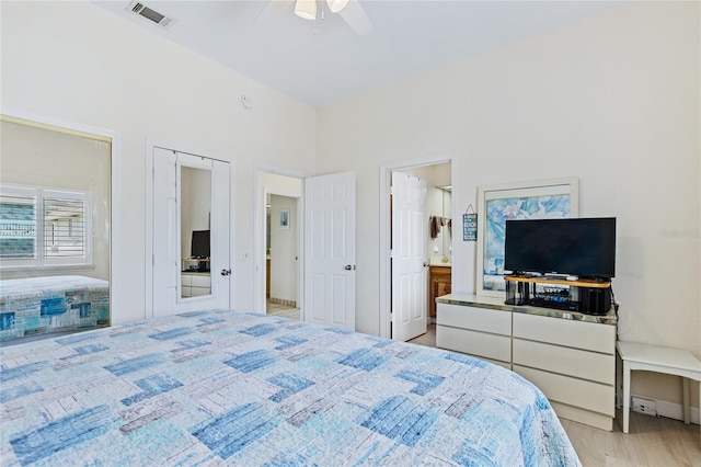 6320 S Atlantic Ave, New Smyrna Beach, FL 32169 - bedroom featuring wood finished floors, connected bathroom, and a ceiling fan