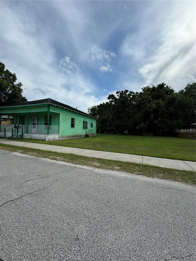 306 Sheldon St, New Smyrna Beach, FL 32168 - view of side of property with a porch and a yard