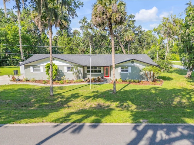 1144 Corbin Park Rd, New Smyrna Beach, FL 32168 - ranch-style house with a front yard and view of wooded area