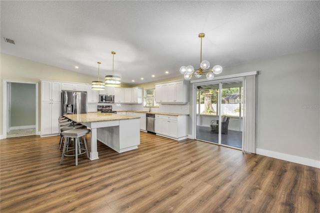 1144 Corbin Park Rd, New Smyrna Beach, FL 32168 - kitchen with stainless steel appliances, white cabinetry, dark wood finished floors, and recessed lighting