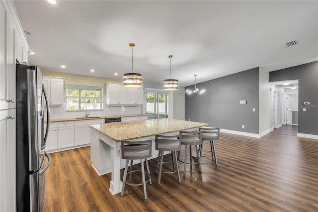 1144 Corbin Park Rd, New Smyrna Beach, FL 32168 - kitchen with freestanding refrigerator, a sink, a kitchen island, black dishwasher, and dark wood-style flooring