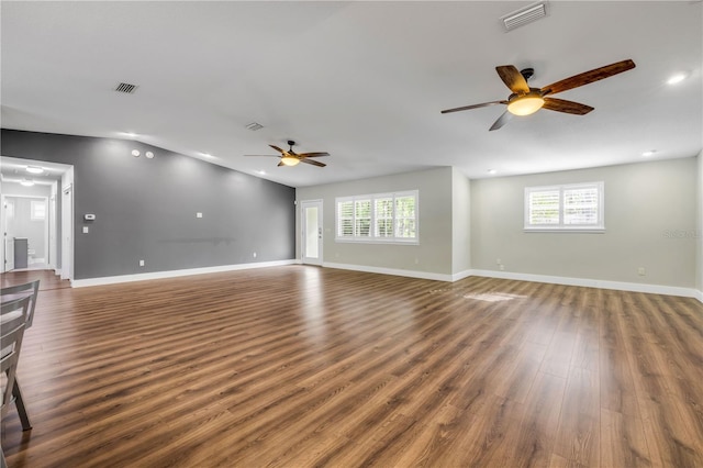 1144 Corbin Park Rd, New Smyrna Beach, FL 32168 - unfurnished living room featuring ceiling fan, plenty of natural light, wood finished floors, baseboards, and recessed lighting
