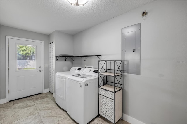 1144 Corbin Park Rd, New Smyrna Beach, FL 32168 - laundry room with electric panel, washer and clothes dryer, baseboards, and a textured ceiling