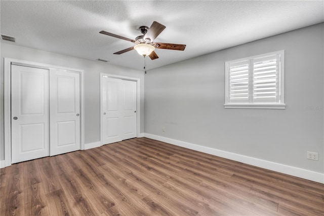 1144 Corbin Park Rd, New Smyrna Beach, FL 32168 - unfurnished bedroom with wood finished floors, baseboards, a textured ceiling, and a ceiling fan