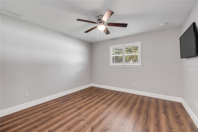 1144 Corbin Park Rd, New Smyrna Beach, FL 32168 - unfurnished room featuring wood finished floors, a ceiling fan, and baseboards