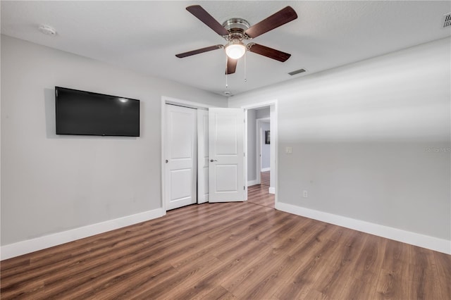 1144 Corbin Park Rd, New Smyrna Beach, FL 32168 - unfurnished bedroom featuring baseboards, wood finished floors, a closet, and ceiling fan