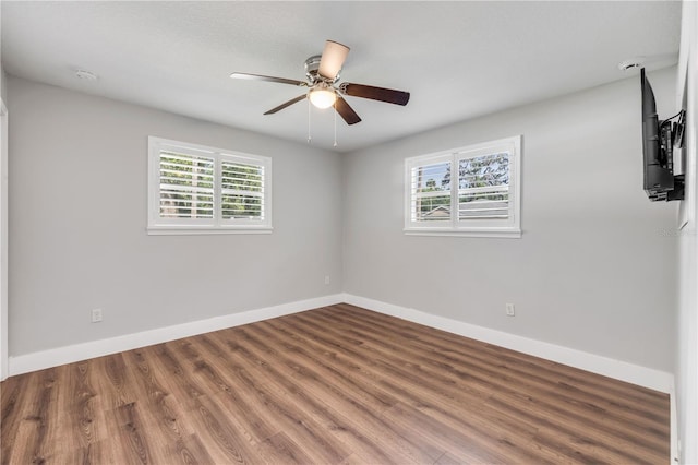 1144 Corbin Park Rd, New Smyrna Beach, FL 32168 - empty room with baseboards, wood finished floors, and a ceiling fan