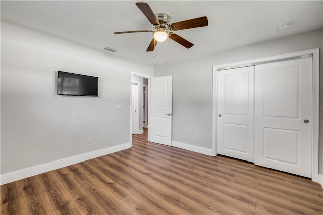 1144 Corbin Park Rd, New Smyrna Beach, FL 32168 - unfurnished bedroom with wood finished floors, baseboards, a closet, and ceiling fan