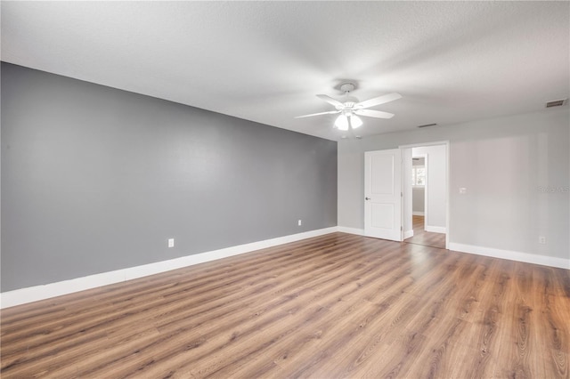 1144 Corbin Park Rd, New Smyrna Beach, FL 32168 - empty room with a ceiling fan, wood finished floors, and baseboards