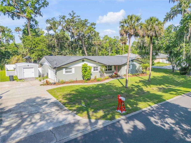 1144 Corbin Park Rd, New Smyrna Beach, FL 32168 - ranch-style home featuring driveway, a front yard, and an outbuilding