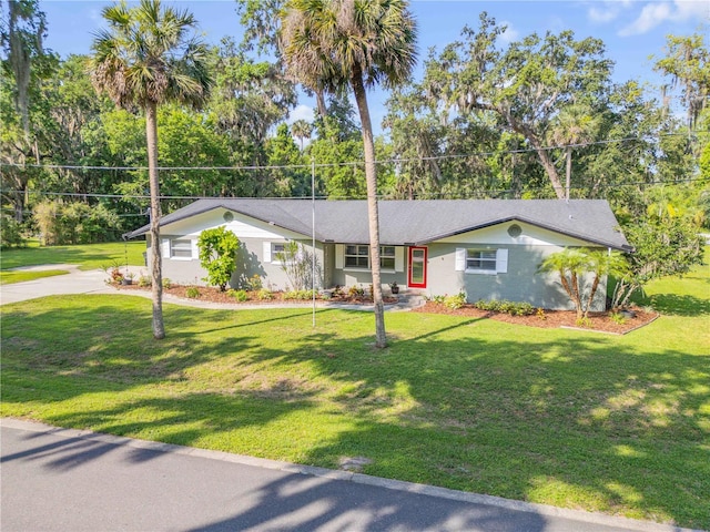 1144 Corbin Park Rd, New Smyrna Beach, FL 32168 - ranch-style home featuring a front yard and driveway