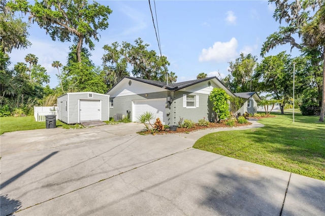 1144 Corbin Park Rd, New Smyrna Beach, FL 32168 - view of home's exterior featuring a lawn, central air condition unit, driveway, and a garage