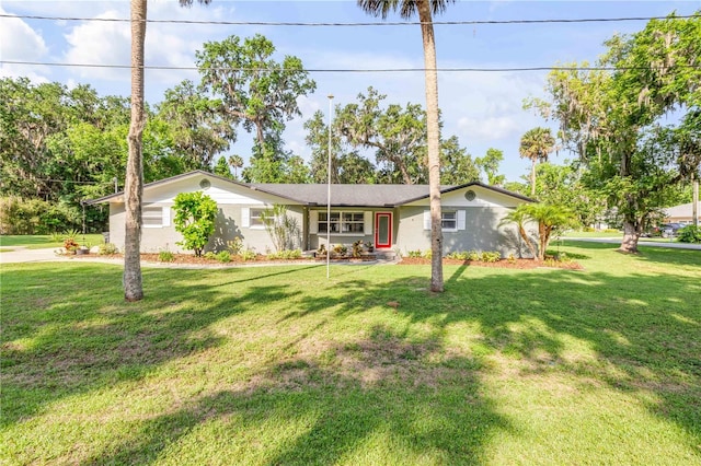1144 Corbin Park Rd, New Smyrna Beach, FL 32168 - ranch-style house featuring a front lawn