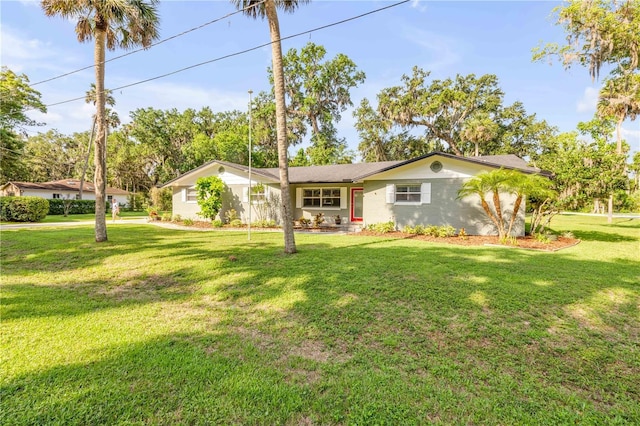1144 Corbin Park Rd, New Smyrna Beach, FL 32168 - ranch-style home with a front yard and stucco siding
