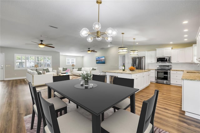 1144 Corbin Park Rd, New Smyrna Beach, FL 32168 - dining room featuring ceiling fan, recessed lighting, light wood-type flooring, a chandelier, and lofted ceiling