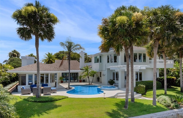 1215 Commodore Dr, New Smyrna Beach, FL 32168 - outdoor pool featuring an in-ground hot tub, a patio, a lawn, and outdoor lounge area