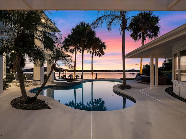 1215 Commodore Dr, New Smyrna Beach, FL 32168 - view of swimming pool featuring a patio, a water view, and a pool with connected hot tub