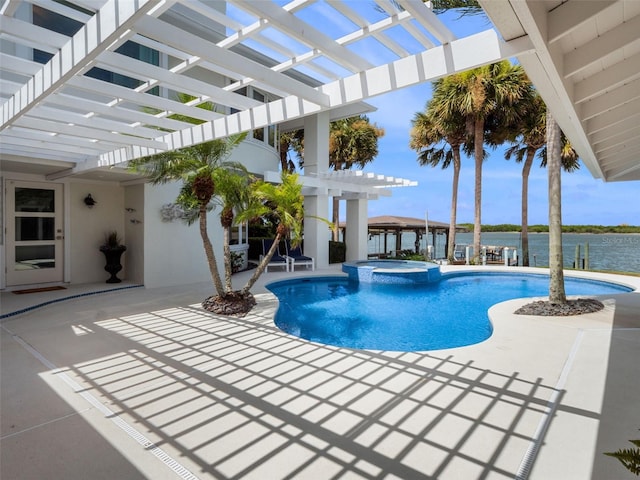 1215 Commodore Dr, New Smyrna Beach, FL 32168 - view of pool featuring a pergola, a pool with connected hot tub, a patio, and a water view
