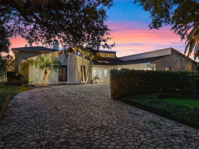 1215 Commodore Dr, New Smyrna Beach, FL 32168 - mid-century home with stucco siding and decorative driveway