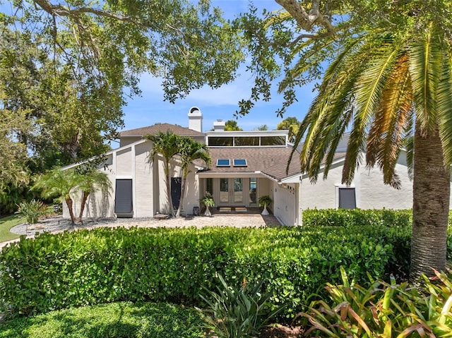 1215 Commodore Dr, New Smyrna Beach, FL 32168 - rear view of house featuring stucco siding and french doors