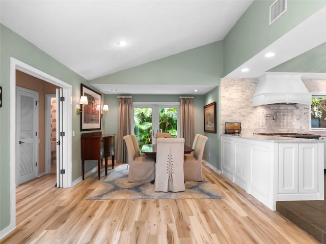 1215 Commodore Dr, New Smyrna Beach, FL 32168 - dining room with vaulted ceiling, light wood-type flooring, and recessed lighting