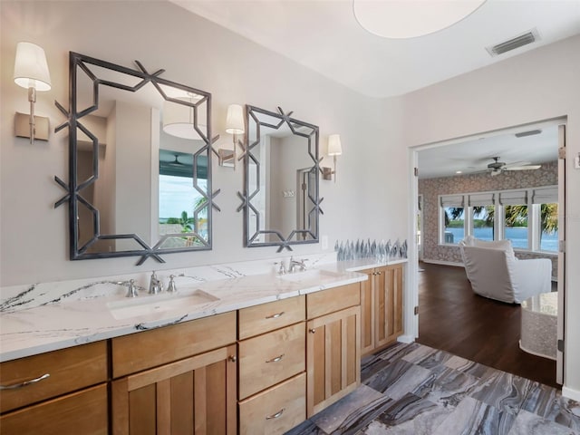 1215 Commodore Dr, New Smyrna Beach, FL 32168 - full bathroom with double vanity and ceiling fan