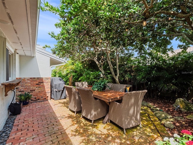 1215 Commodore Dr, New Smyrna Beach, FL 32168 - view of patio featuring grilling area and outdoor dining space