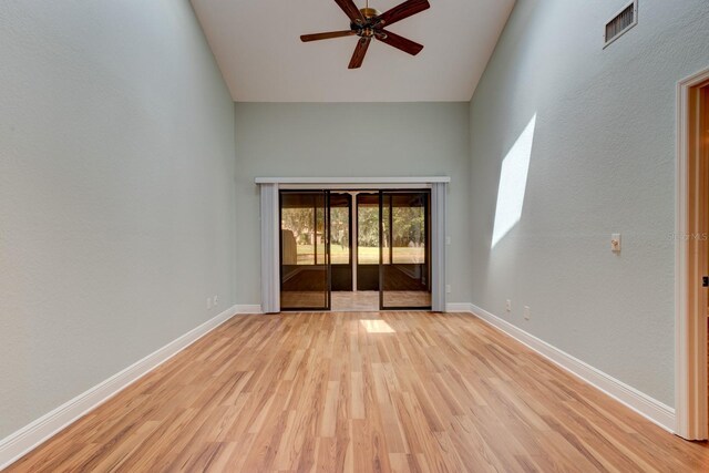 488 Shorewood Ln, New Smyrna Beach, FL 32168 - spare room with light wood finished floors, ceiling fan, baseboards, and high vaulted ceiling