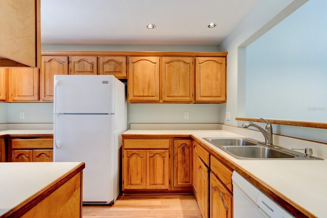 488 Shorewood Ln, New Smyrna Beach, FL 32168 - kitchen with white appliances, a sink, light countertops, light wood finished floors, and recessed lighting