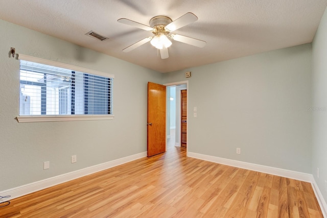 488 Shorewood Ln, New Smyrna Beach, FL 32168 - unfurnished room featuring light wood finished floors, a ceiling fan, baseboards, and a textured ceiling