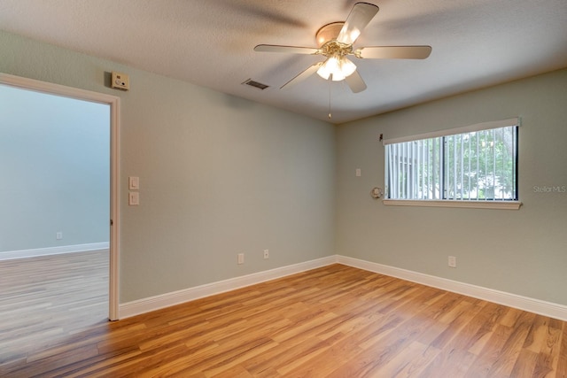 488 Shorewood Ln, New Smyrna Beach, FL 32168 - unfurnished room featuring light wood finished floors, ceiling fan, baseboards, and a textured ceiling