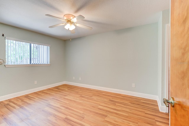 488 Shorewood Ln, New Smyrna Beach, FL 32168 - spare room with light wood-style flooring, ceiling fan, baseboards, and a textured ceiling