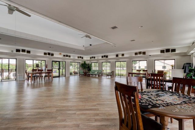 488 Shorewood Ln, New Smyrna Beach, FL 32168 - dining room with a ceiling fan, light wood finished floors, and a tray ceiling