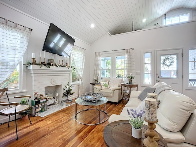 216 Murray St, New Smyrna Beach, FL 32168 - living area featuring lofted ceiling, a fireplace, wood finished floors, healthy amount of natural light, and wood ceiling