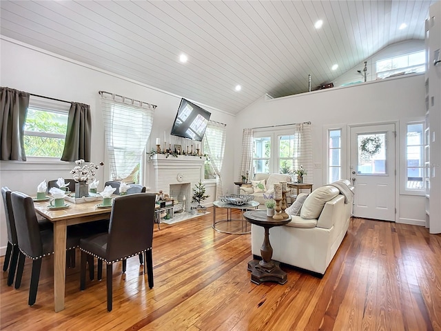 216 Murray St, New Smyrna Beach, FL 32168 - living room featuring wood-type flooring, lofted ceiling, healthy amount of natural light, recessed lighting, and a brick fireplace
