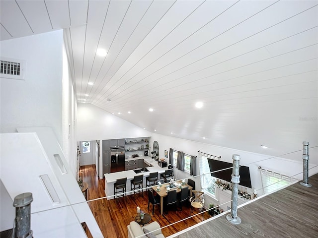 216 Murray St, New Smyrna Beach, FL 32168 - living area featuring wood finished floors, healthy amount of natural light, lofted ceiling, and recessed lighting