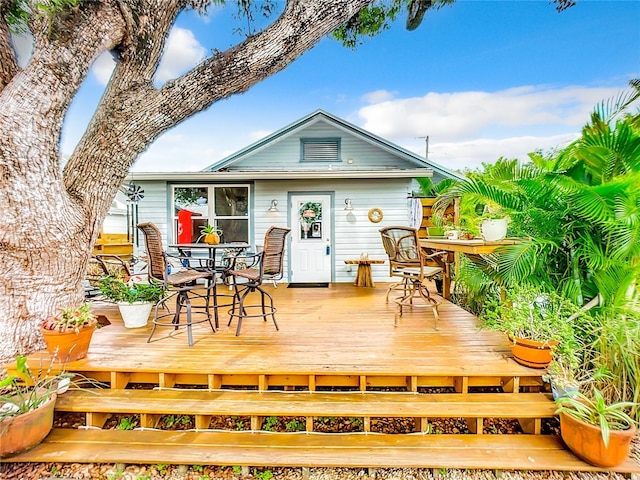 216 Murray St, New Smyrna Beach, FL 32168 - back of house with outdoor dining area and a wooden deck