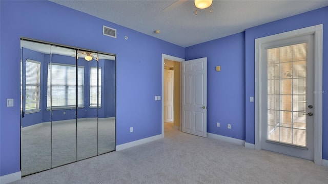 4620 Riverwalk Village Ct Unit 7306, Ponce Inlet, FL 32127 - unfurnished bedroom featuring carpet floors, a closet, baseboards, a ceiling fan, and a textured ceiling