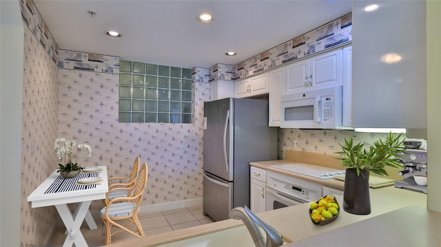4620 Riverwalk Village Ct Unit 7306, Ponce Inlet, FL 32127 - kitchen featuring white appliances, white cabinetry, light countertops, light tile patterned floors, and recessed lighting