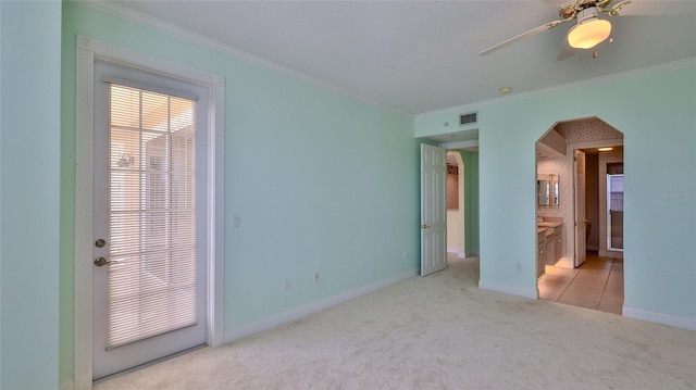 4620 Riverwalk Village Ct Unit 7306, Ponce Inlet, FL 32127 - unfurnished bedroom featuring ornamental molding, carpet floors, arched walkways, baseboards, and connected bathroom