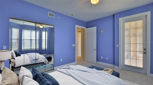 4620 Riverwalk Village Ct Unit 7306, Ponce Inlet, FL 32127 - carpeted bedroom featuring a closet, a ceiling fan, a textured ceiling, and baseboards