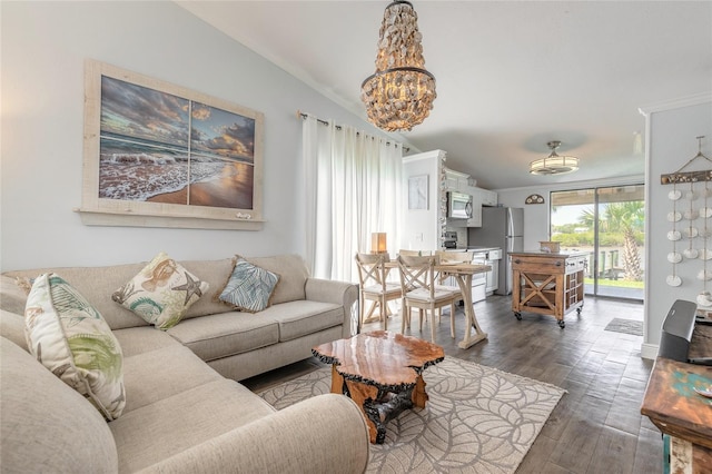 76 Heather Point Ct, New Smyrna Beach, FL 32169 - living area featuring a chandelier, wood finished floors, vaulted ceiling, and ornamental molding