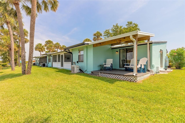 76 Heather Point Ct, New Smyrna Beach, FL 32169 - rear view of property featuring stucco siding, ac unit, a lawn, and a sunroom