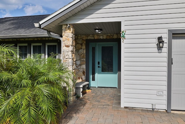 475 Spruceview Dr, Port Orange, FL 32127 - view of exterior entry with a shingled roof and stone siding